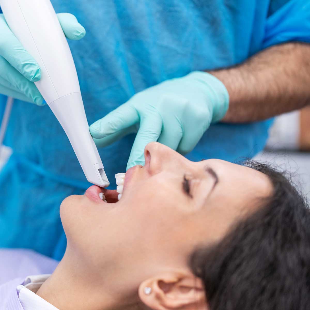 Dentist conducting a digital scan of the patient's teeth