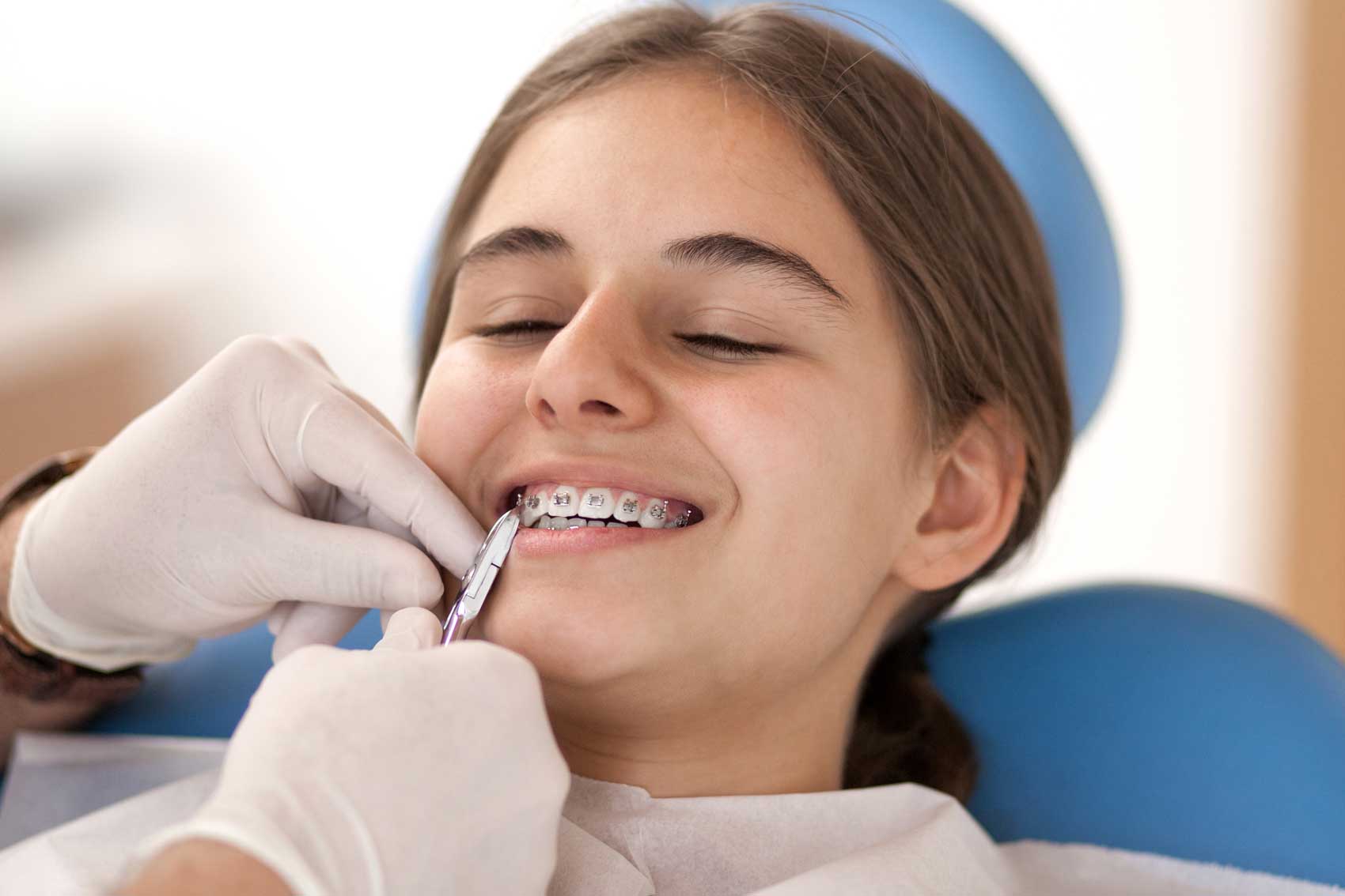 Girl getting braces fitted by the dentist